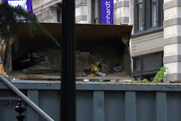 NYC construction crew dumping material into truck