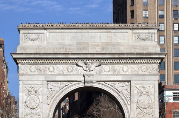 Pigeons sitting together on the Washington Square Park arch