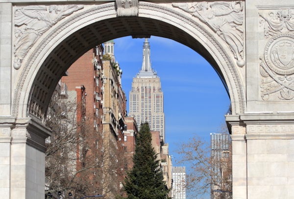 Empire State Building and the Christmas Tree seen under the Washington Square Park arch