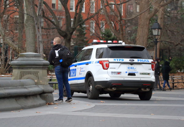 NYPD vehicle driving through Washington Square Park
