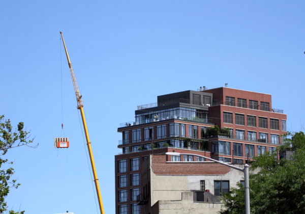 Construction crane next to NYC apartment building